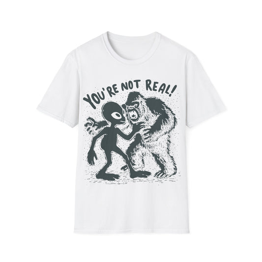 Funny alien and Bigfoot design with cartoon alien arguing with roaring sasquatch under the slogan You're Not Real on white t-shirt