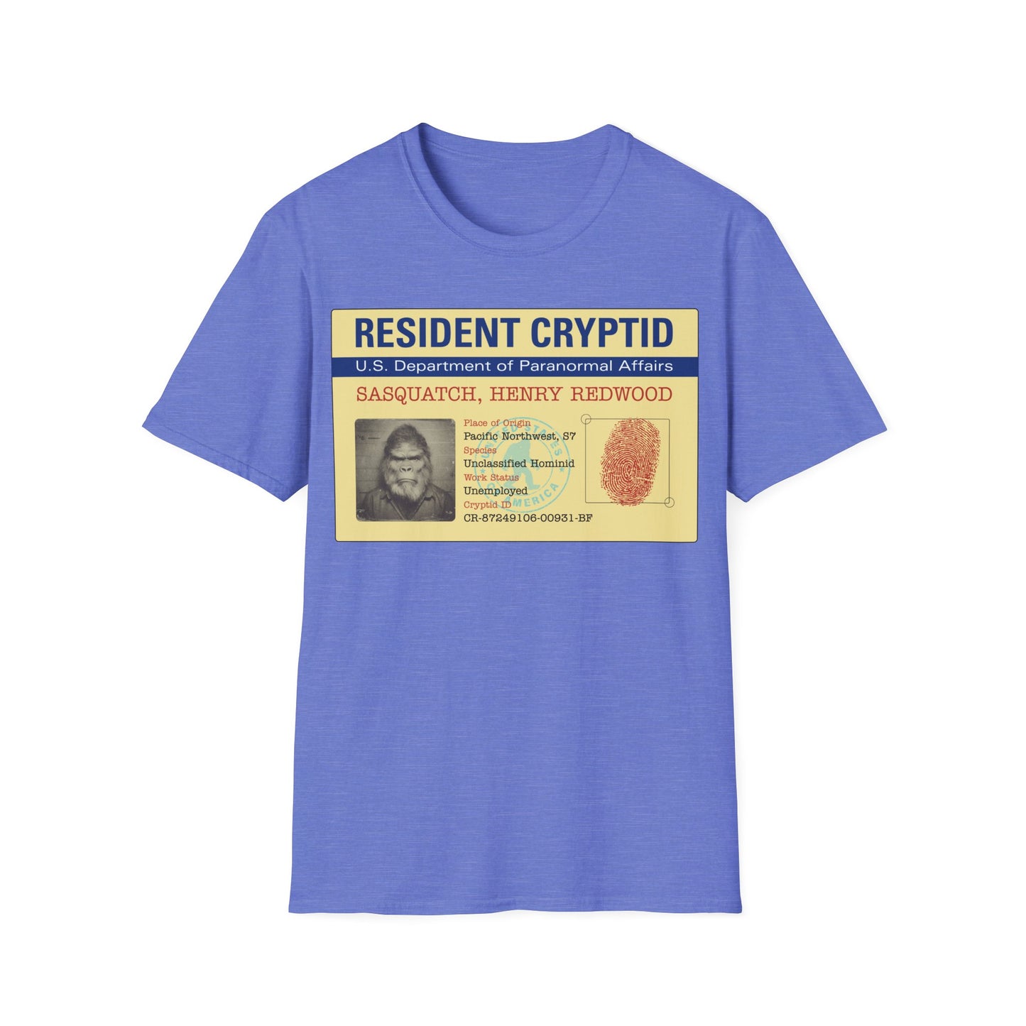 Resident Cryptid ID Card t-shirt design featuring a vintage government style Sasquatch/Bigfoot ID badge with mugshot portrait, fingerprint, and ‘U.S. Department of Paranormal Affairs’ dossier text in beige, blue, and red on a heather royal blue background