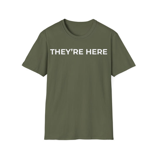 They’re Here t-shirt design, featuring bold white uppercase typography reading “THEY’RE HERE” in a clean minimalist text based layout on a military green background
