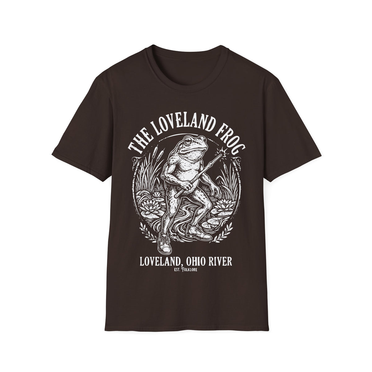 Loveland Frog t-shirt design, featuring a humanoid frog holding a glowing wand in a marsh filled with reeds and lily pads, framed by bold “The Loveland Frog” and “Loveland, Ohio River” lettering in a detailed vintage folklore illustration on a dark chocolate brown background