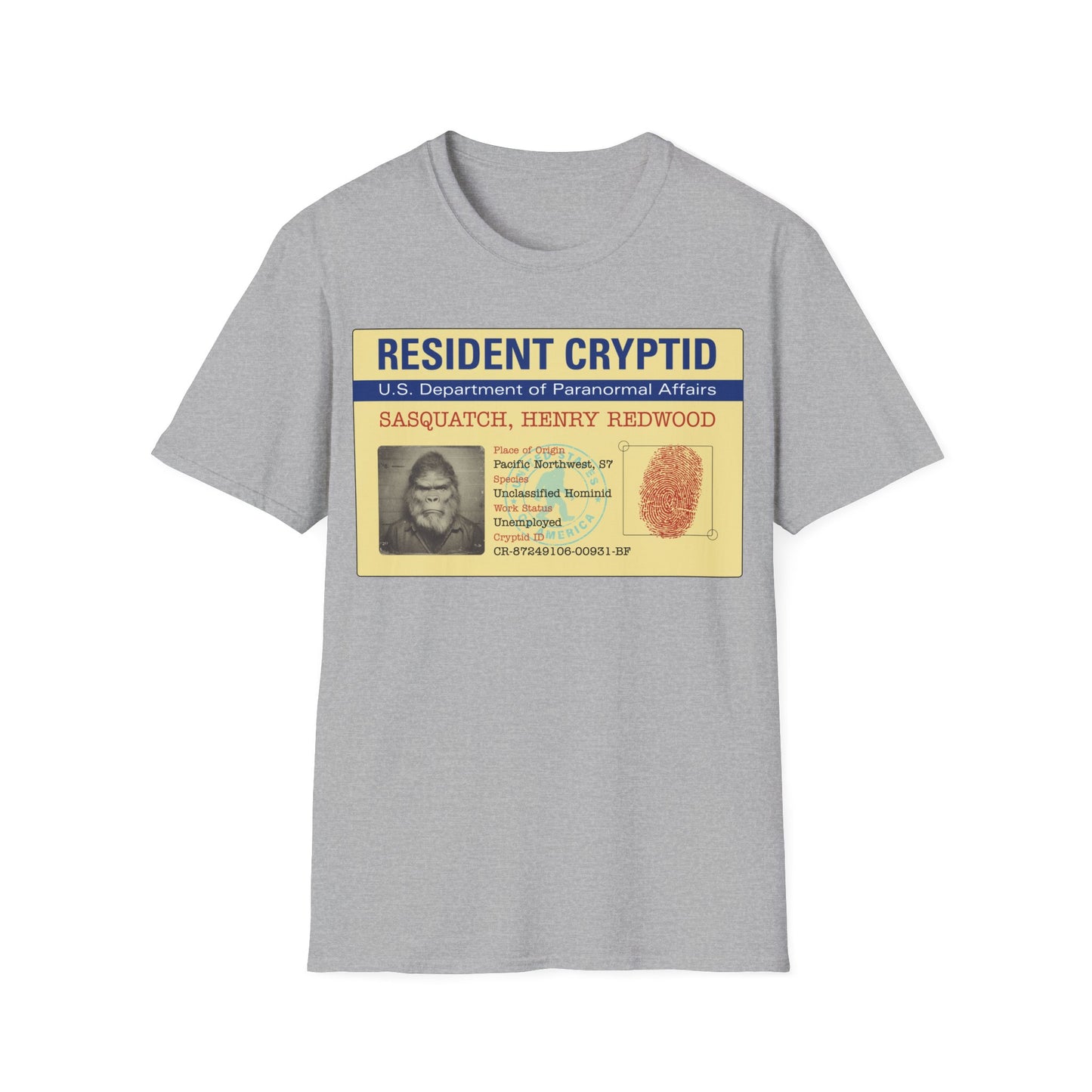 Resident Cryptid ID Card t-shirt design featuring a vintage government style Sasquatch/Bigfoot ID badge with mugshot portrait, fingerprint, and ‘U.S. Department of Paranormal Affairs’ dossier text in beige, blue, and red on a sport gray background
