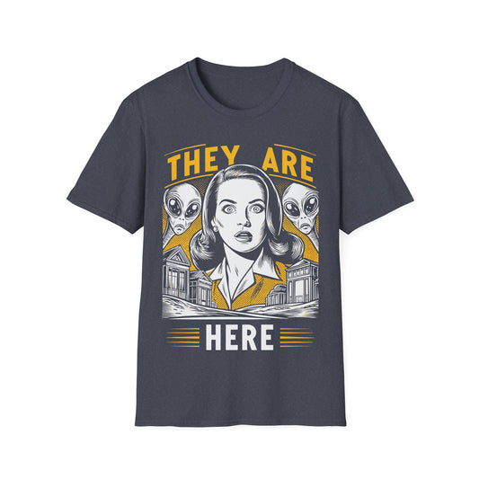 They Are Here Retro t-shirt design, featuring a hypnotized woman with spiral eyes between two grey aliens above a suburban neighborhood in a bold yellow, white, and black vintage comic book style on a dark grey background