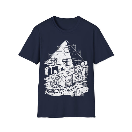 Aliens Building Giza t-shirt design, featuring two grey aliens carving and hauling stone blocks in front of a partially constructed Egyptian pyramid with scaffolding and Eye of Horus symbols in a black and white illustration on a navy blue background